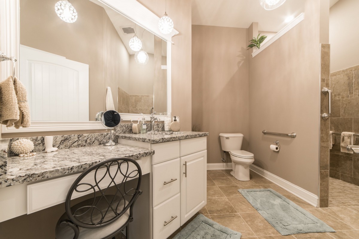 Elegant bathroom featuring a granite countertop vanity and modern fixtures.