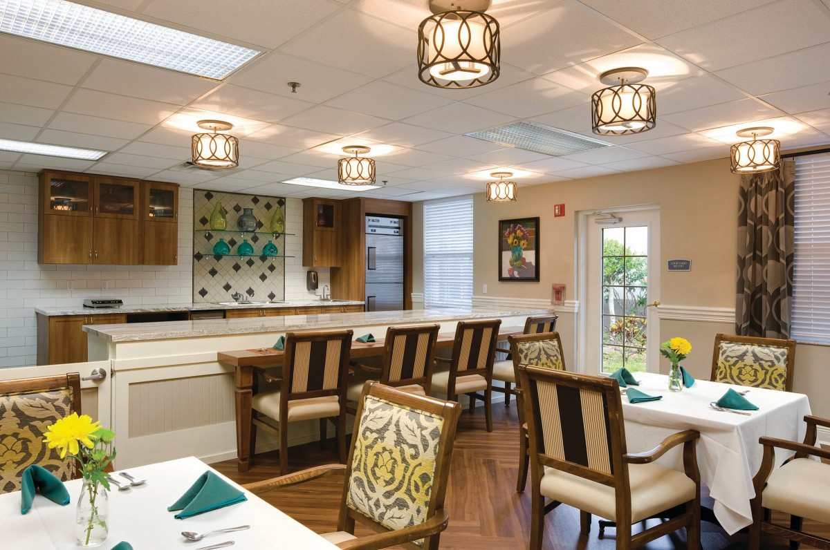 A well-lit dining room with stylish furniture and decorative elements.