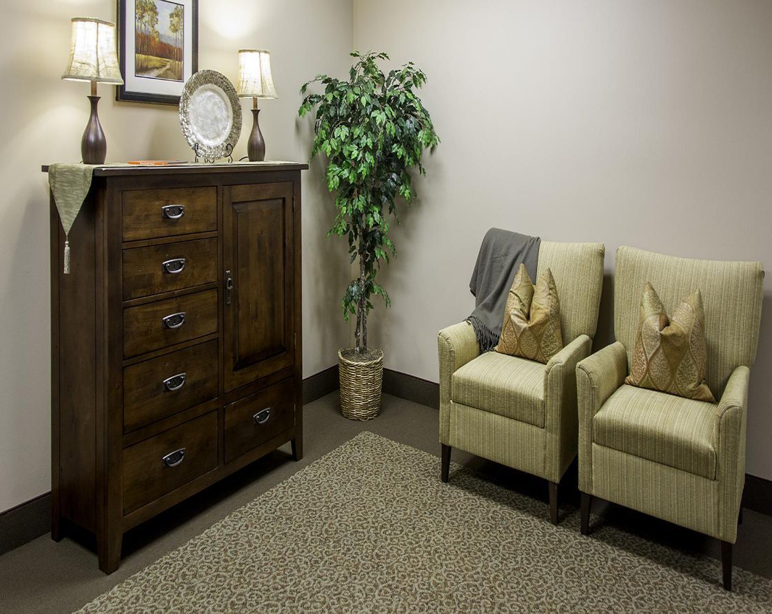 A cozy waiting room with comfortable chairs and elegant decor.