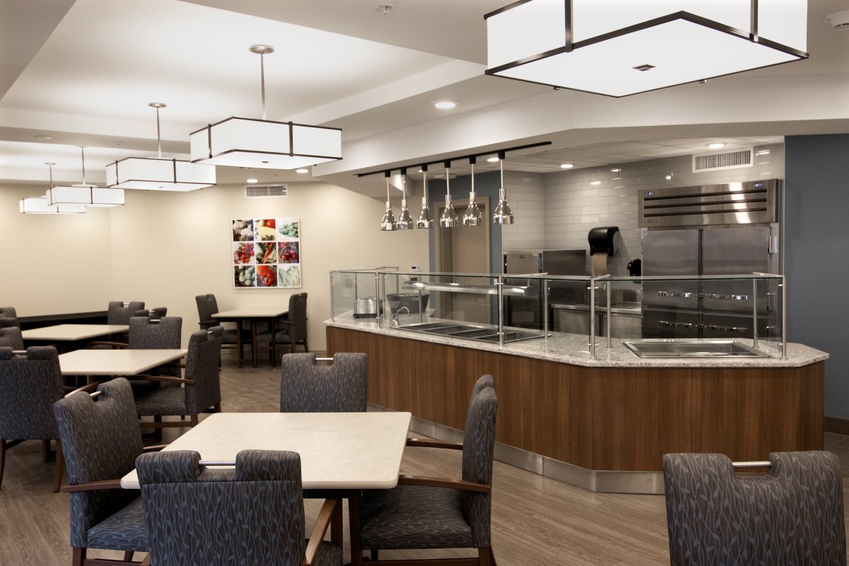 A modern dining area with sleek lighting fixtures and comfortable seating.