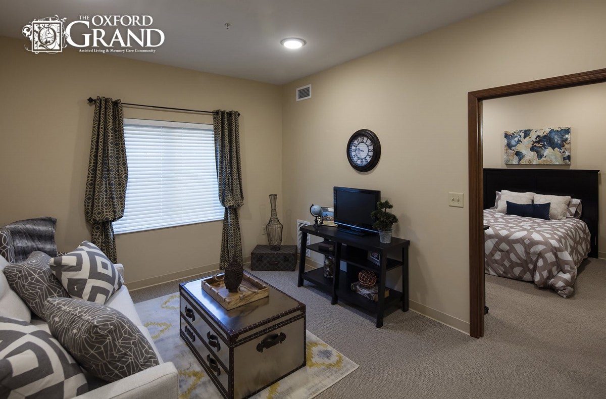 A cozy living room with a television and decorative items.