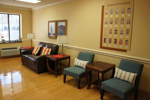 A cozy waiting room featuring comfortable seating arrangements and decorative elements.