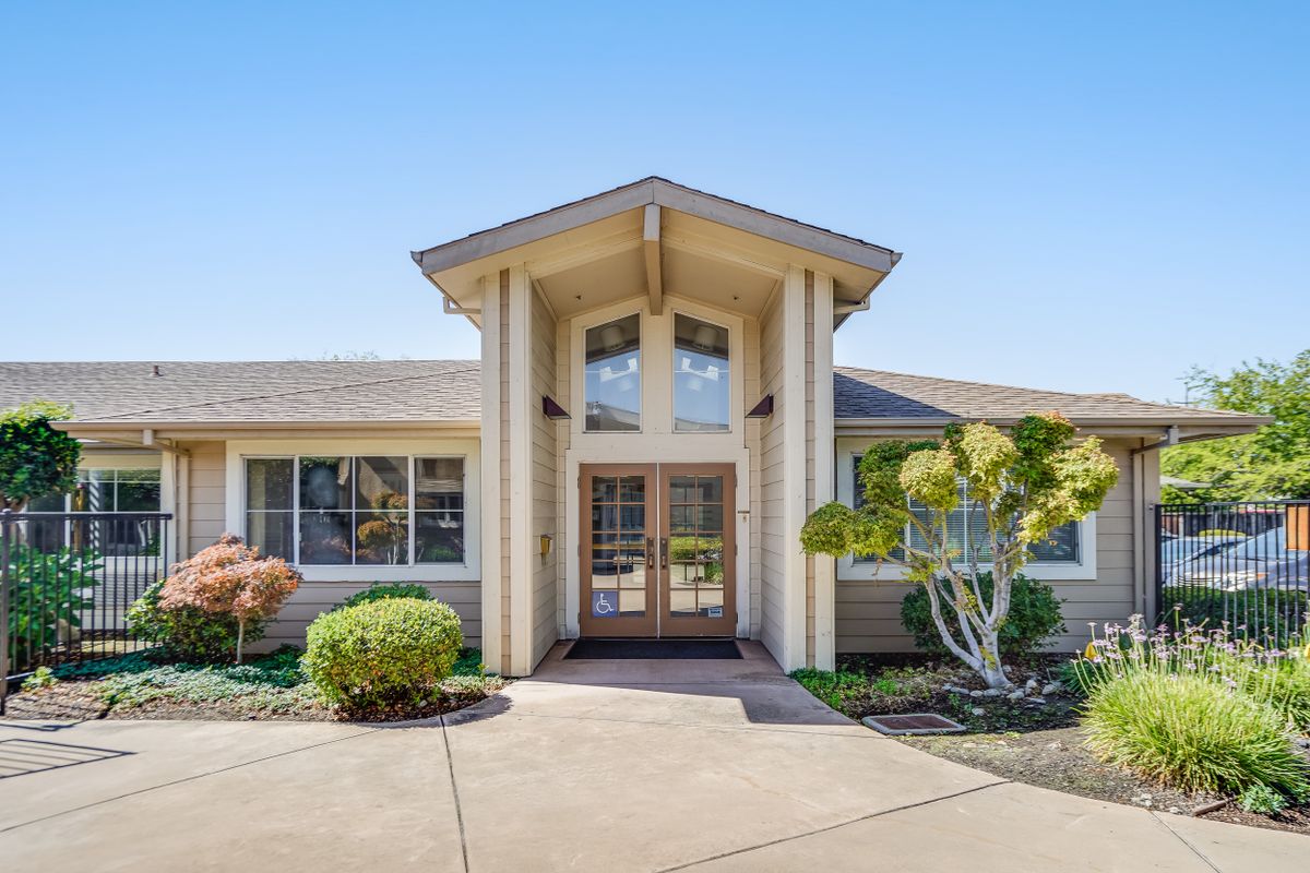 A modern residential building with a well-maintained entrance and landscaping.