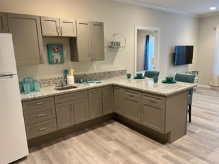Modern kitchen with light brown cabinets and a clean countertop.