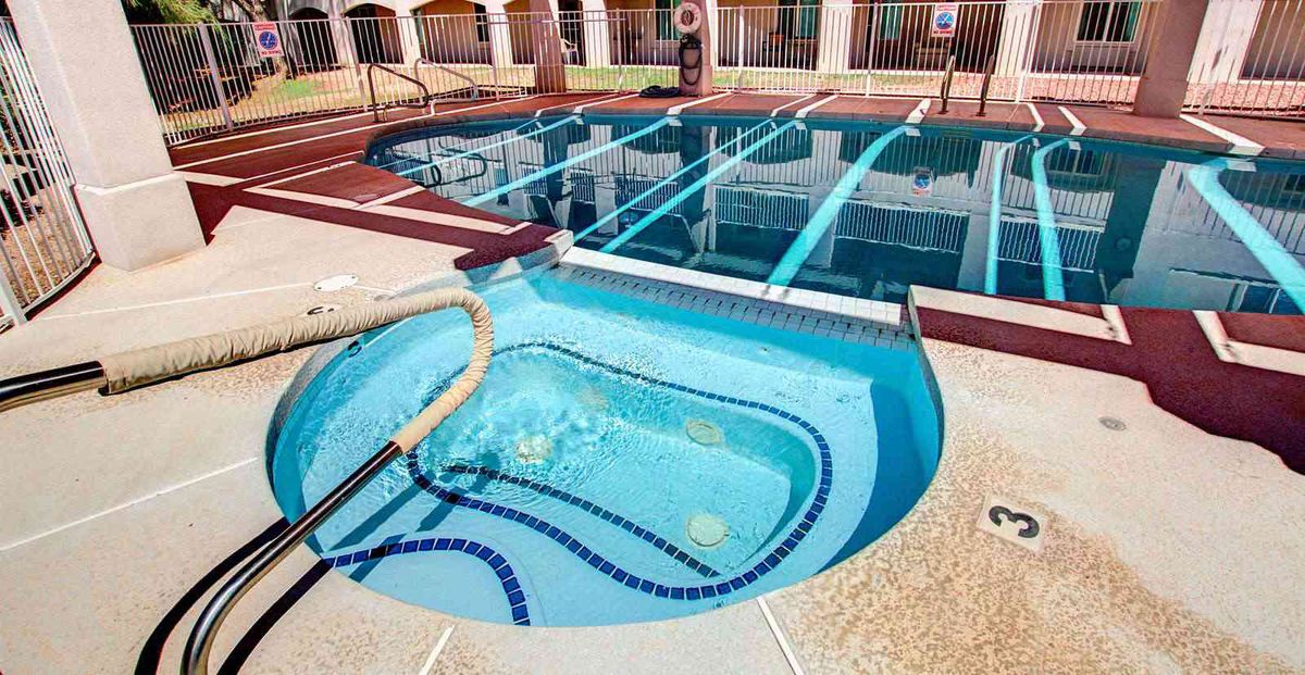 An inviting outdoor swimming pool and jacuzzi area, designed for relaxation.