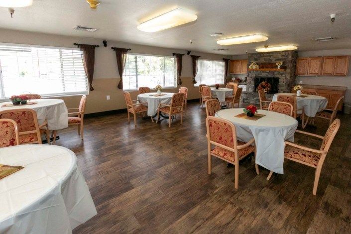 A spacious dining room with neatly arranged tables and chairs.
