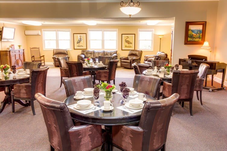 A beautifully set dining area with elegant tables and chairs, perfect for a cozy meal.