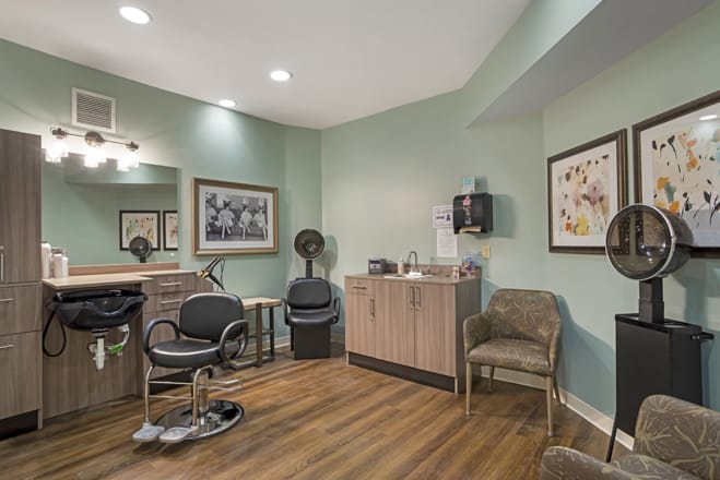 A modern hair salon interior with styling chairs and a waiting area.