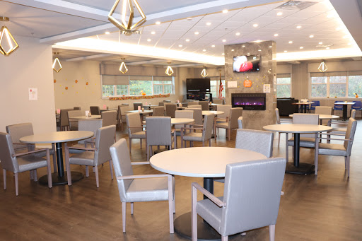 A modern dining room featuring ample seating and contemporary decor.