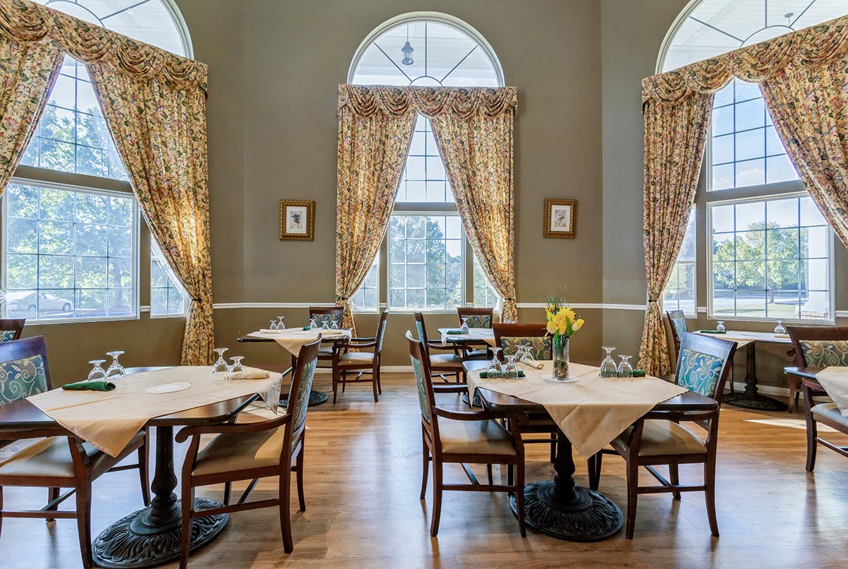 Elegant restaurant interior with classic decor and large windows.