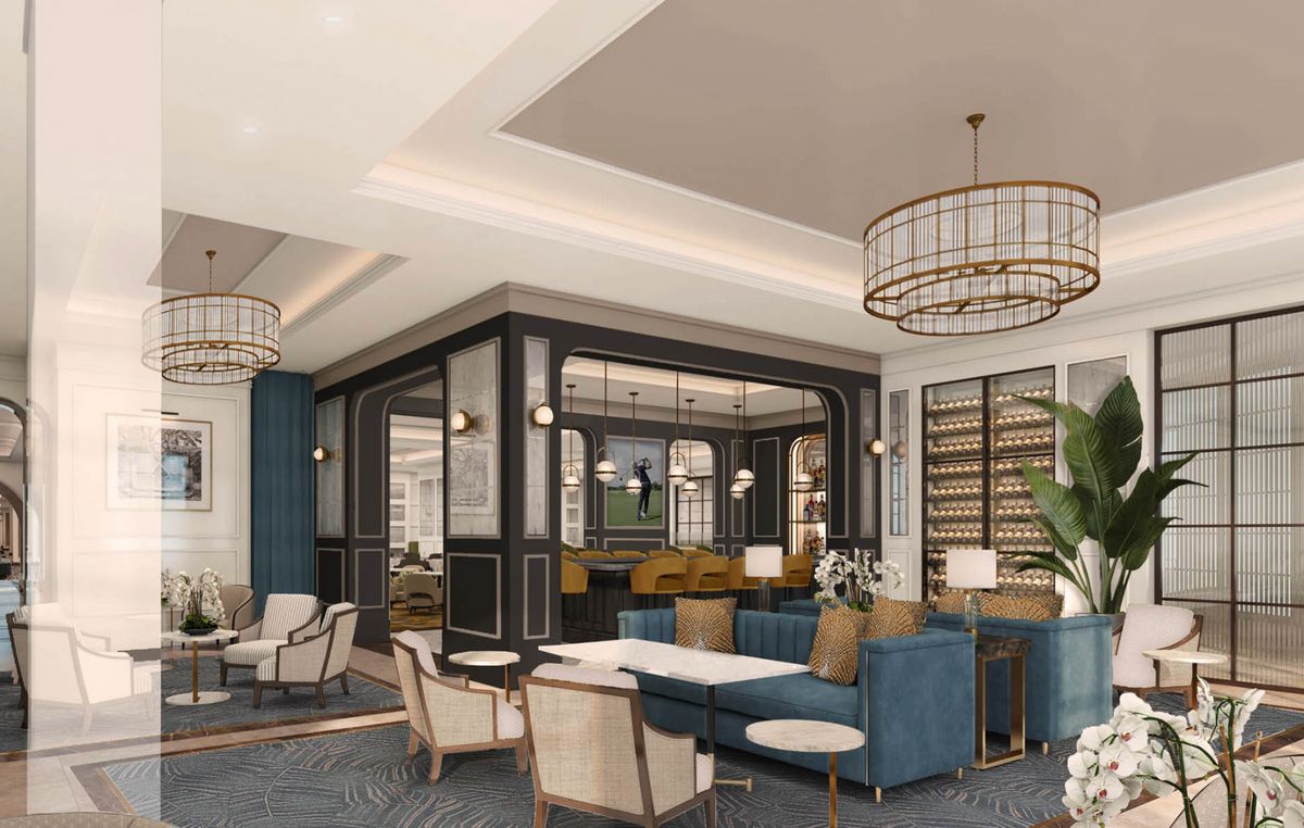 A luxurious lounge area with modern furniture and elegant chandeliers.