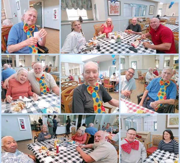A joyful group of seniors enjoying a meal together in a community dining area.