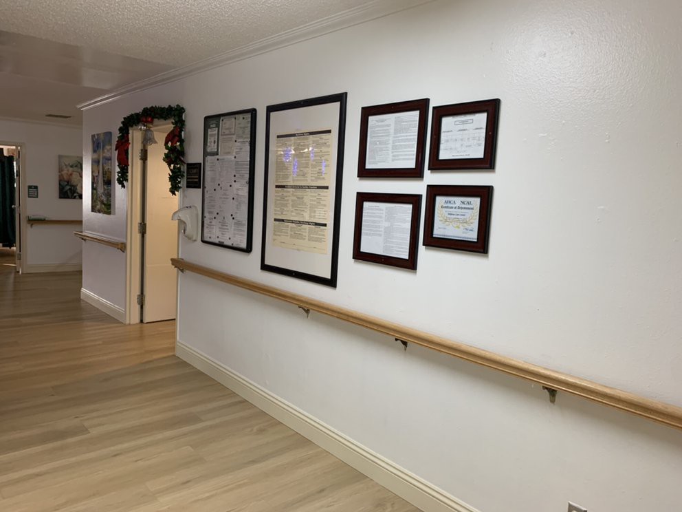 A hallway with framed certificates and decorations on the wall.
