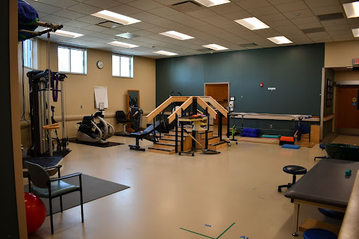 A well-equipped rehabilitation facility featuring various exercise equipment and a dedicated workout area.
