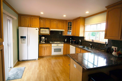 A well-lit modern kitchen featuring wooden cabinets and sleek appliances.