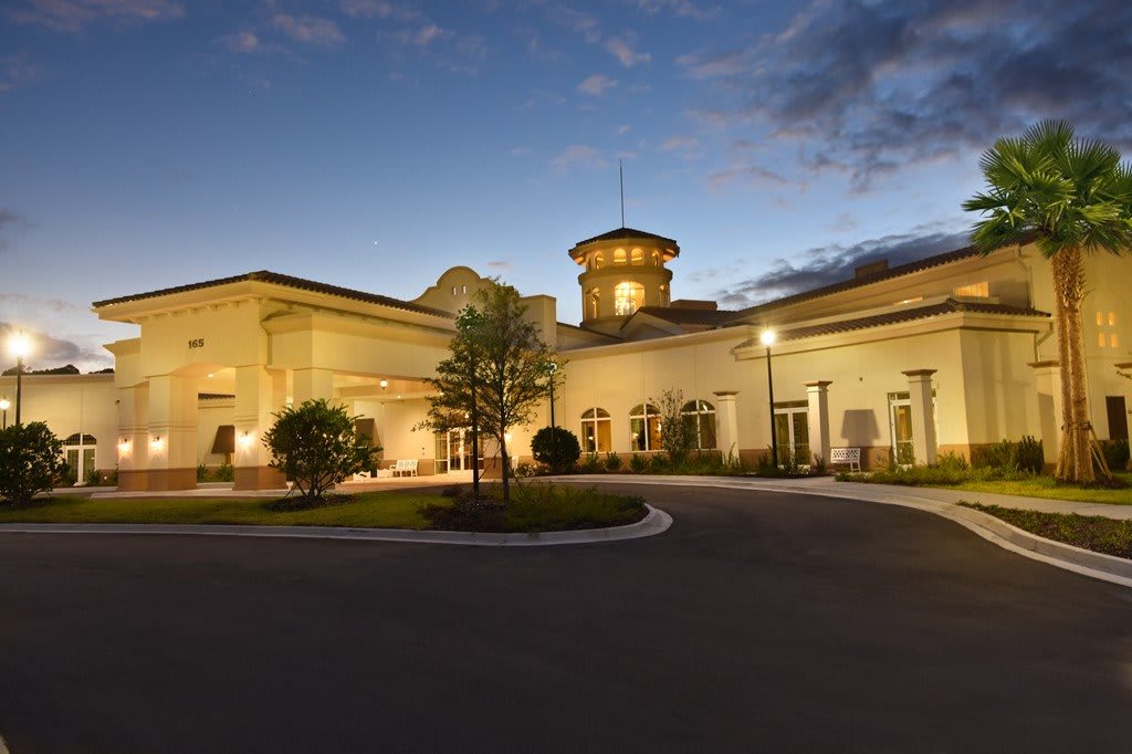 A well-lit building exterior during the evening.