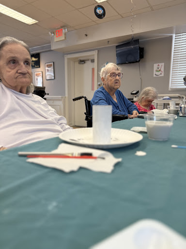 Seniors enjoying a meal together in a community dining area.