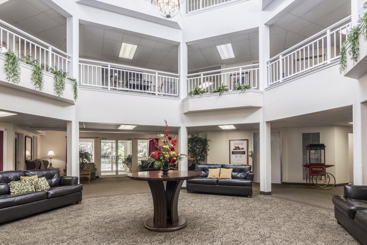 Spacious lobby area with modern furnishings and decorative plants.