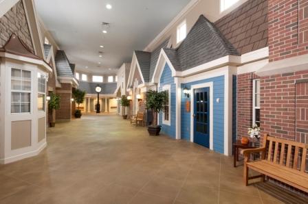 A well-designed interior corridor featuring residential-style entrances, creating a welcoming atmosphere.