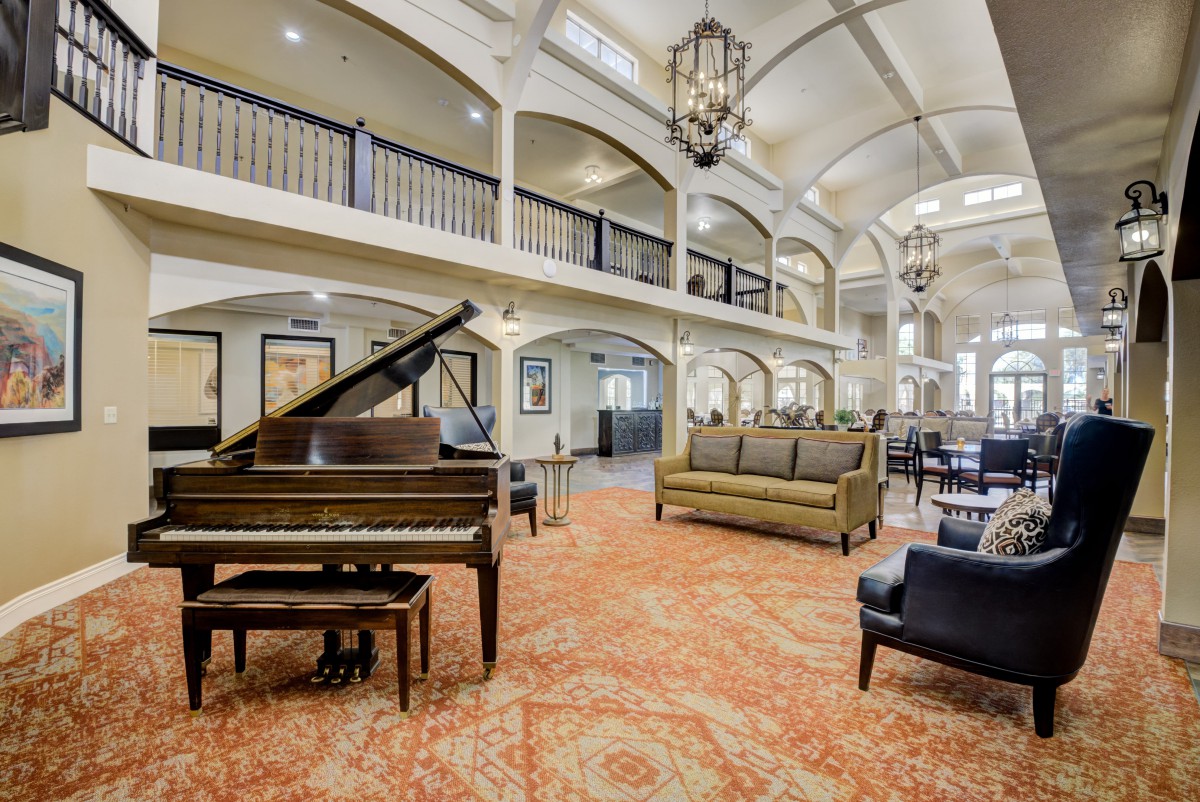 Luxurious lobby with grand piano and elegant seating.