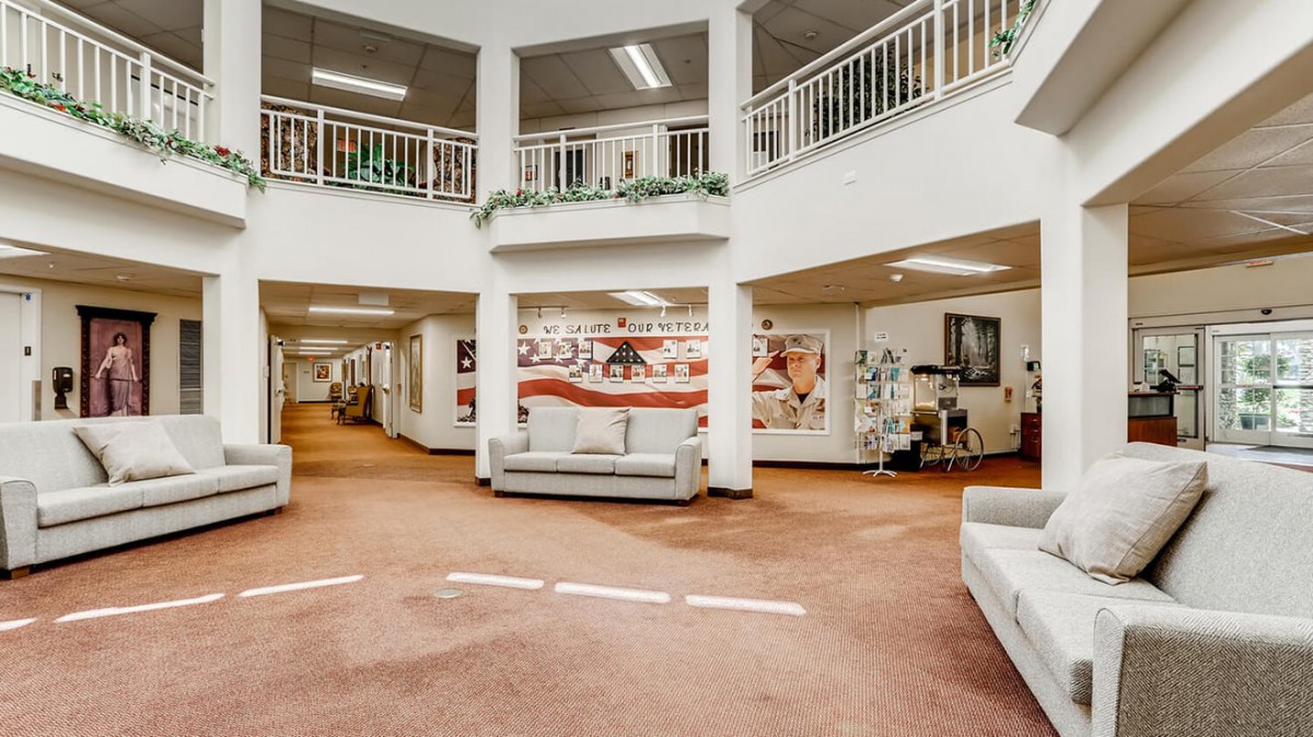 A spacious lobby area with modern furnishings and artwork displayed on the walls.