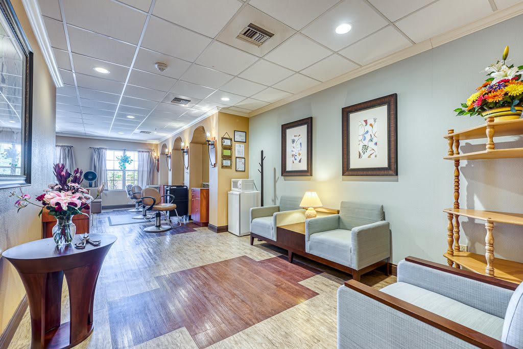 A cozy waiting area with comfortable chairs and framed art on the walls.