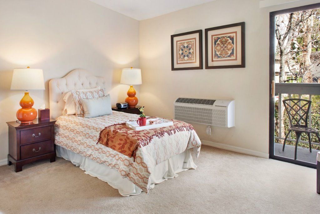 Cozy bedroom with a single bed, decorative elements, and warm lighting.