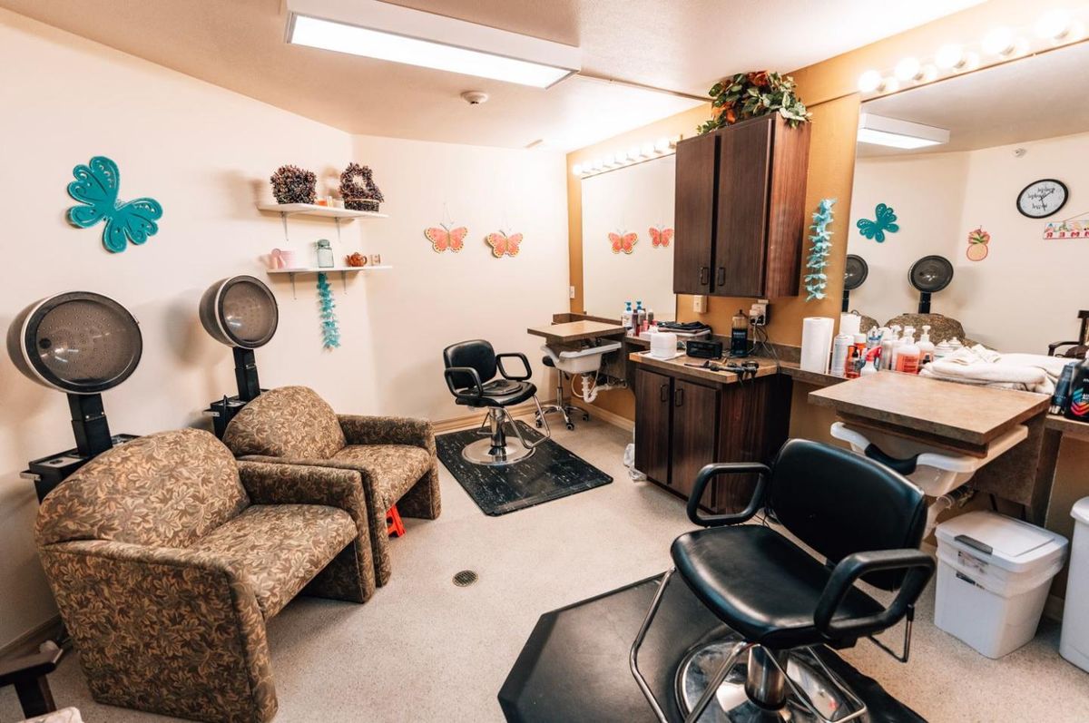 Interior view of a cozy beauty salon with hairstyling chairs and mirrors.