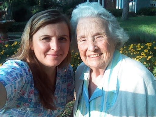 A joyful moment captured between a grandmother and granddaughter enjoying a sunny day outdoors.