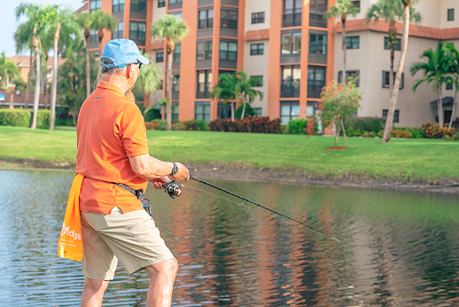 A man enjoys a peaceful day of fishing by the lakeside.