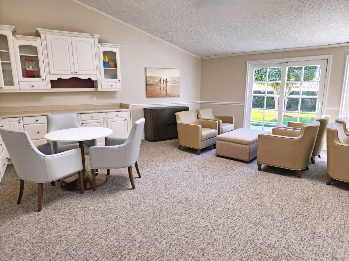 A cozy living room with comfortable seating and a view of the outdoors.