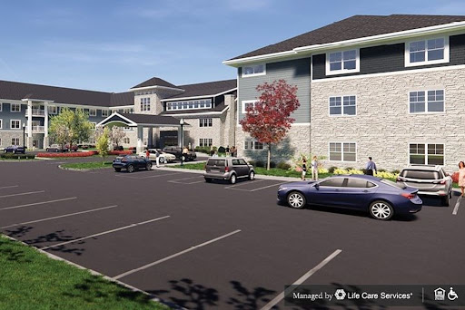 A modern apartment complex featuring well-designed architecture and a spacious parking area.