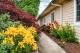 A beautifully landscaped garden with a pathway surrounded by vibrant flowers.