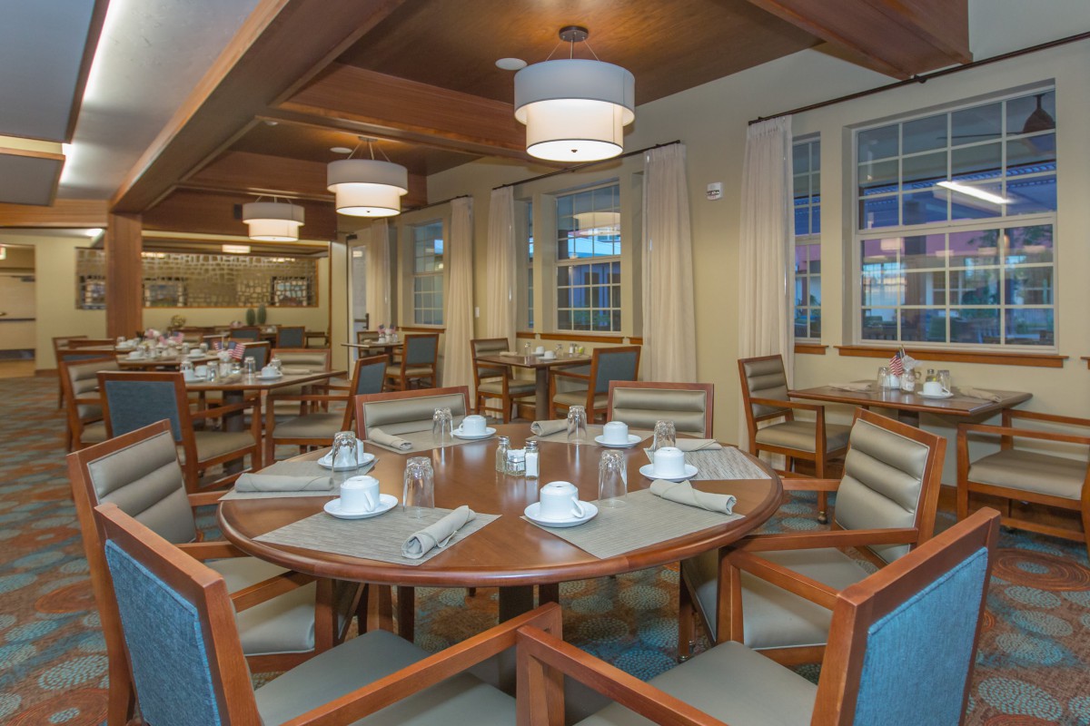 A cozy dining area with a round table set for guests in a restaurant.