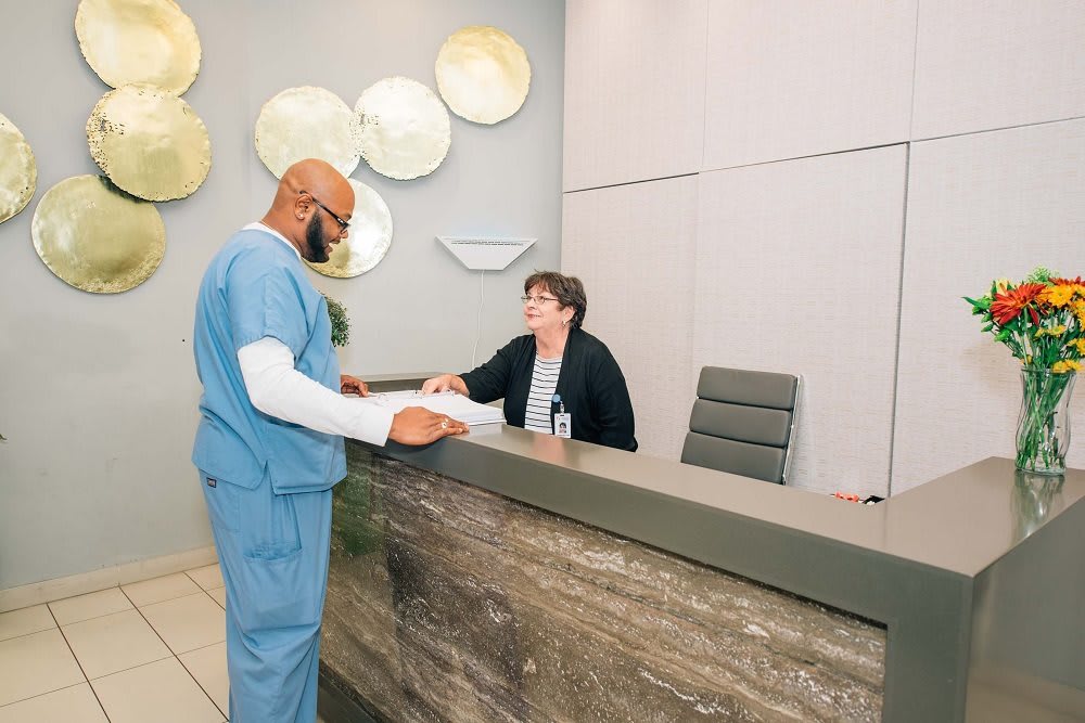 A professional interaction at a medical office reception.
