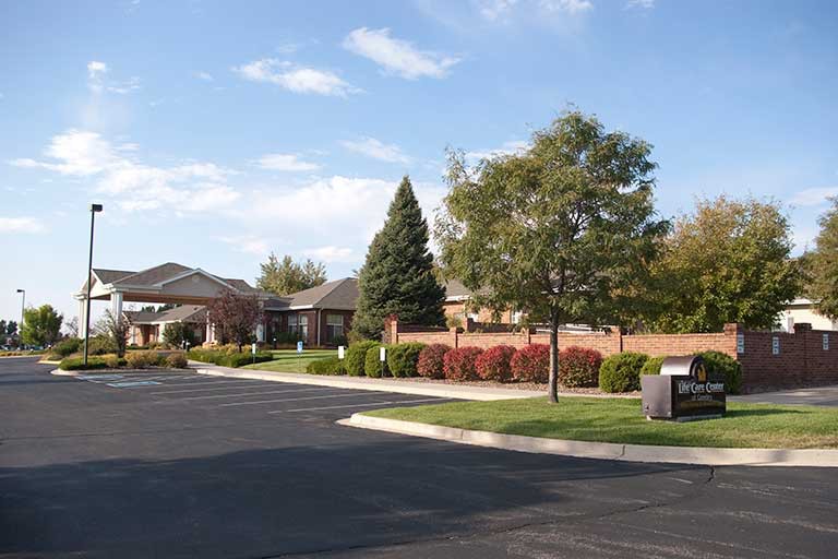 A suburban residential area featuring well-maintained landscaping and a quiet road.