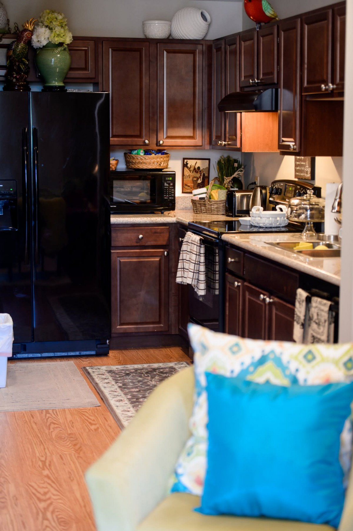 A cozy kitchen with wooden cabinets and modern appliances.