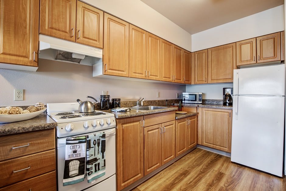 A well-organized kitchen with wooden cabinets and modern appliances.
