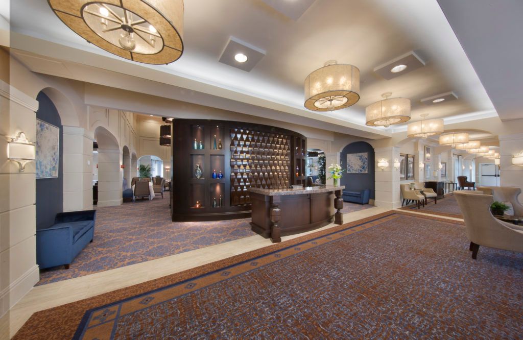 A spacious hotel lobby with elegant lighting and a welcoming reception desk.