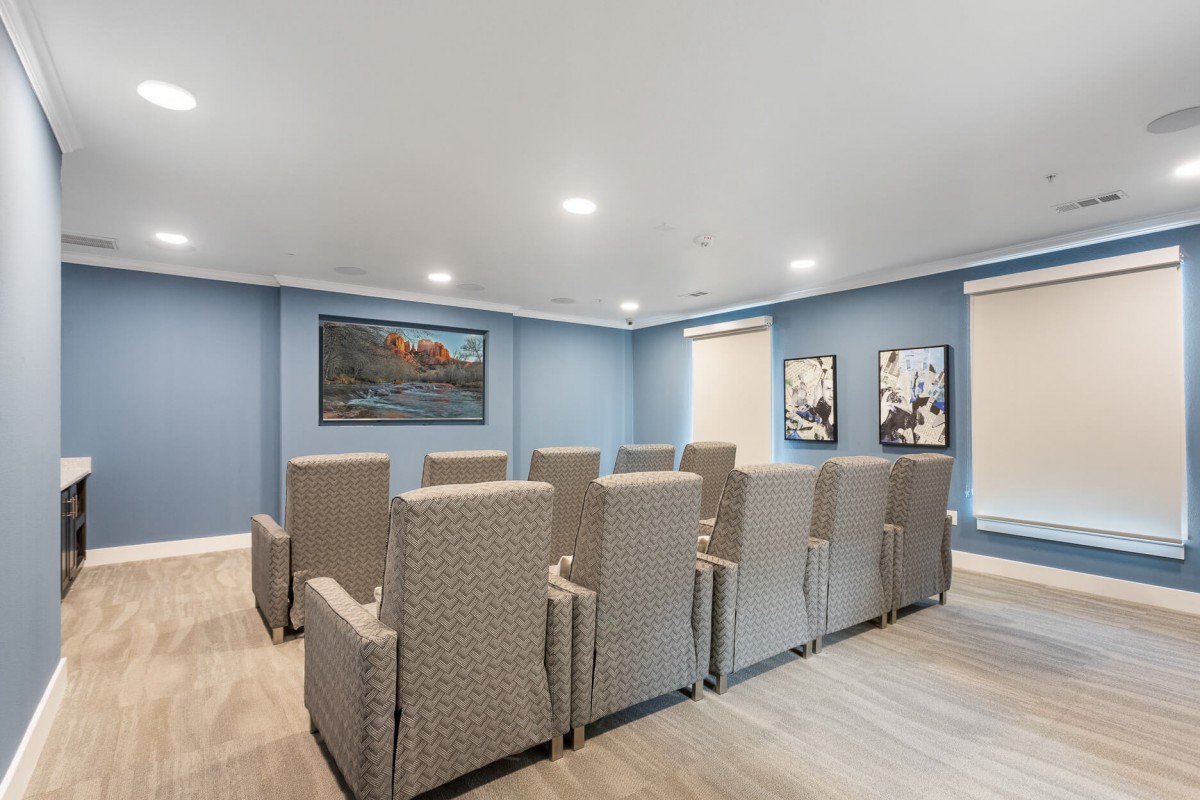 A modern theater room with comfortable seating and elegant decor.