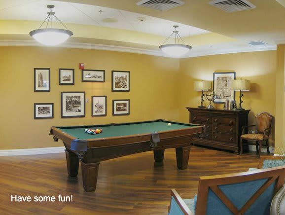 A cozy game room featuring a pool table and classic decor.