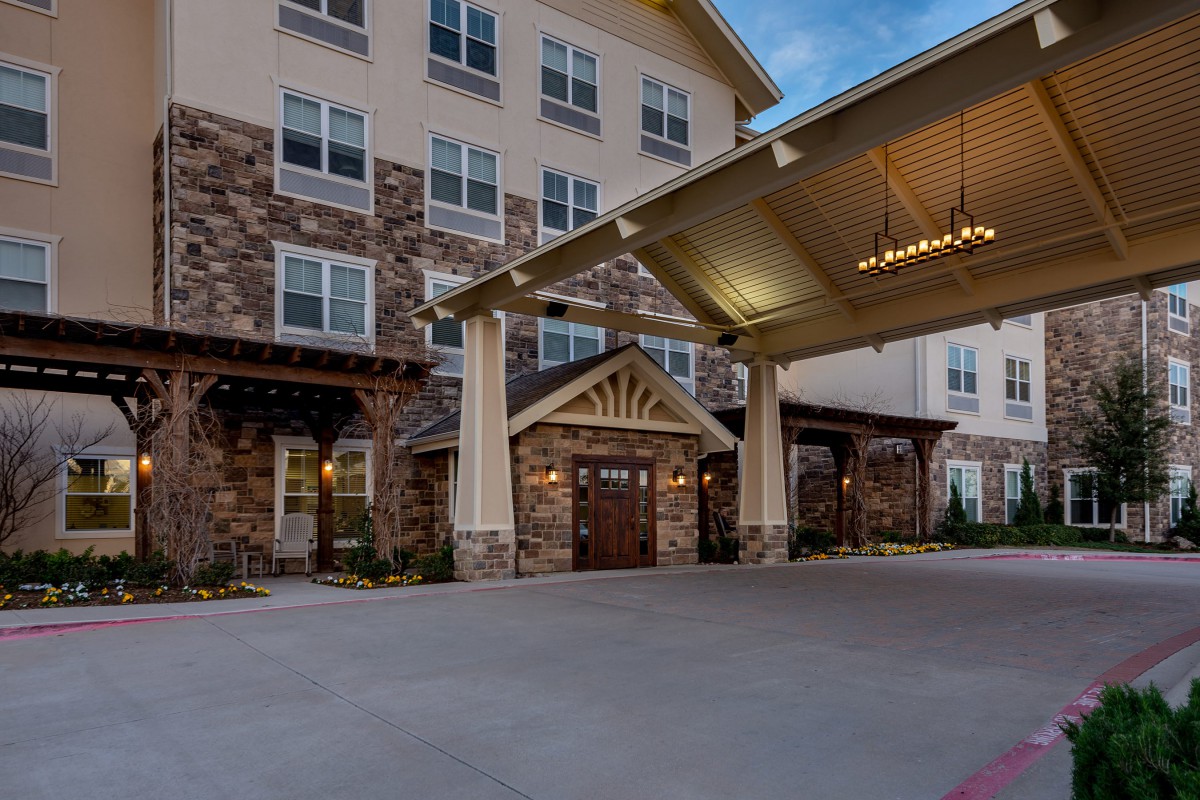 A beautifully lit hotel entrance during the evening.