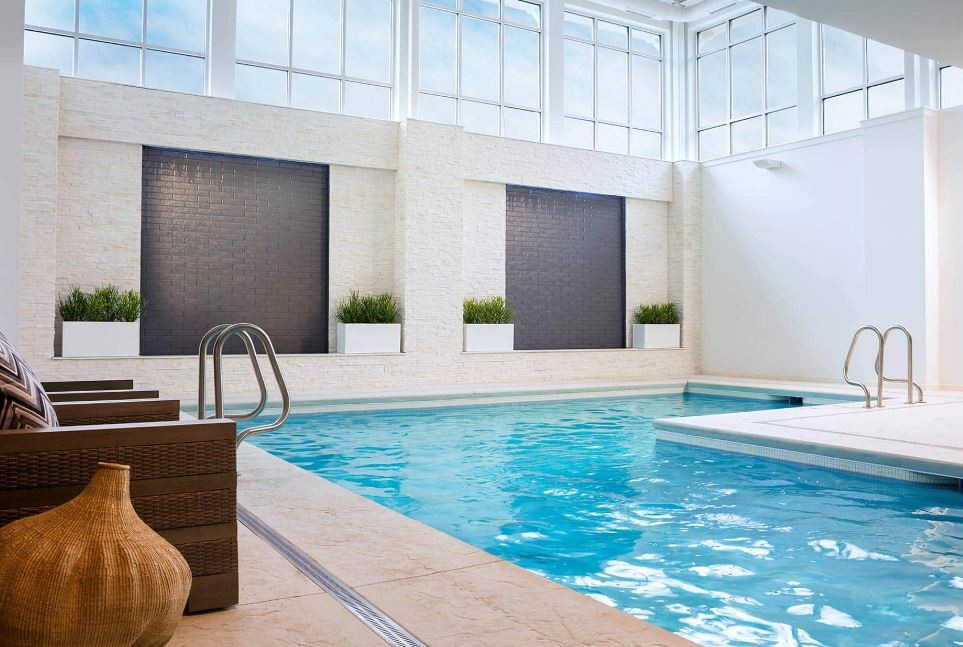 A luxurious indoor swimming pool with a modern design, offering a relaxing environment.