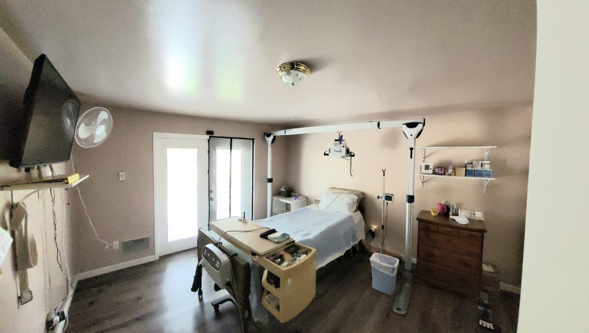 A hospital room with a bed and medical equipment.