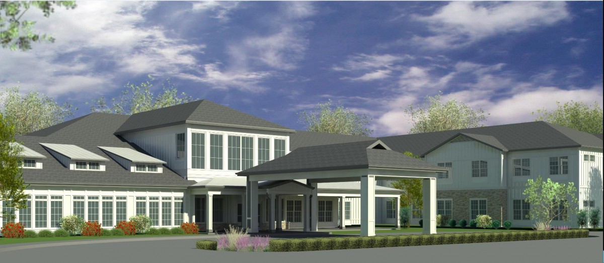 A modern residential building with a multi-story design and landscaped surroundings under a partly cloudy sky.
