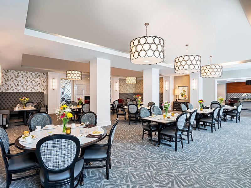 An elegant restaurant dining area with modern decor and lighting fixtures.