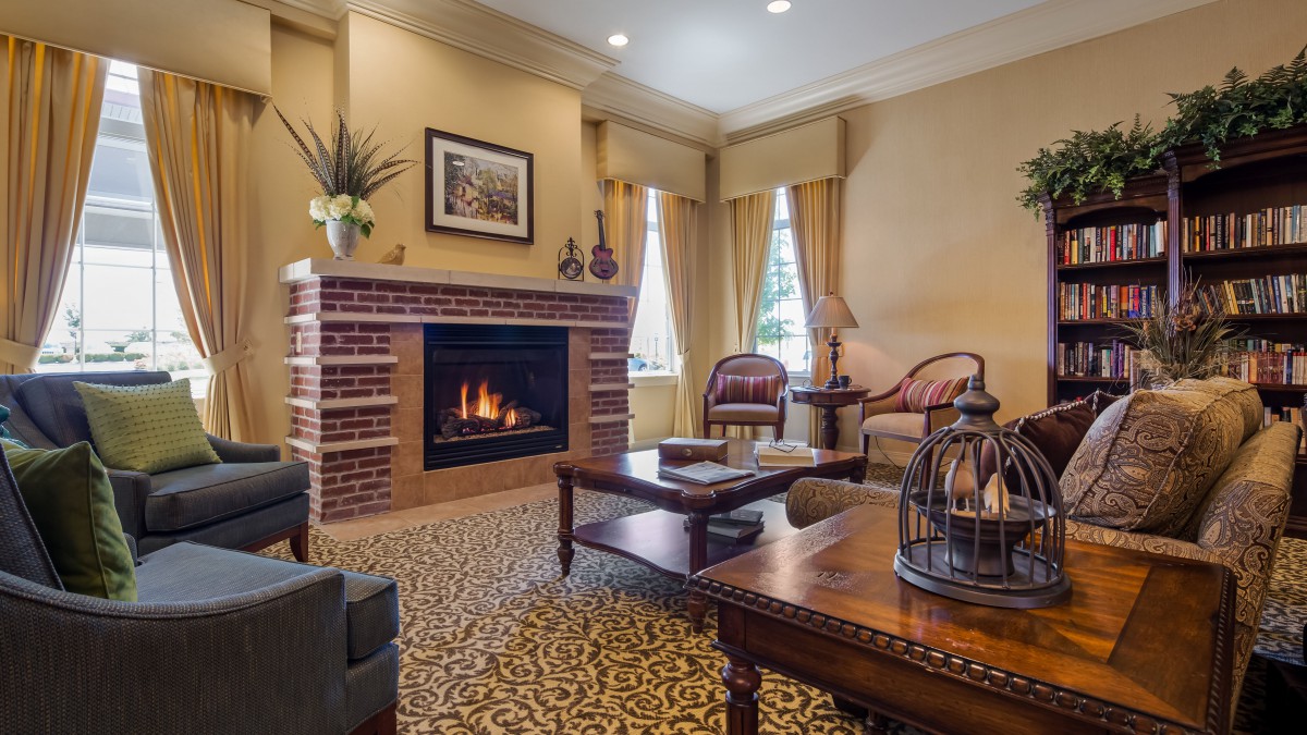 A cozy living room featuring a warm fireplace and elegant decor.