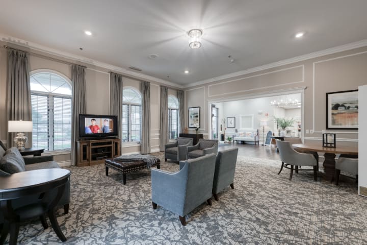 A spacious living room with elegant furnishings and a cozy atmosphere.