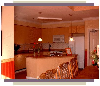 A warm, inviting kitchen with a countertop and bar stools.