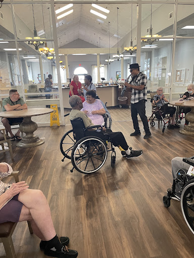 Residents engage in a communal activity at a senior living facility.